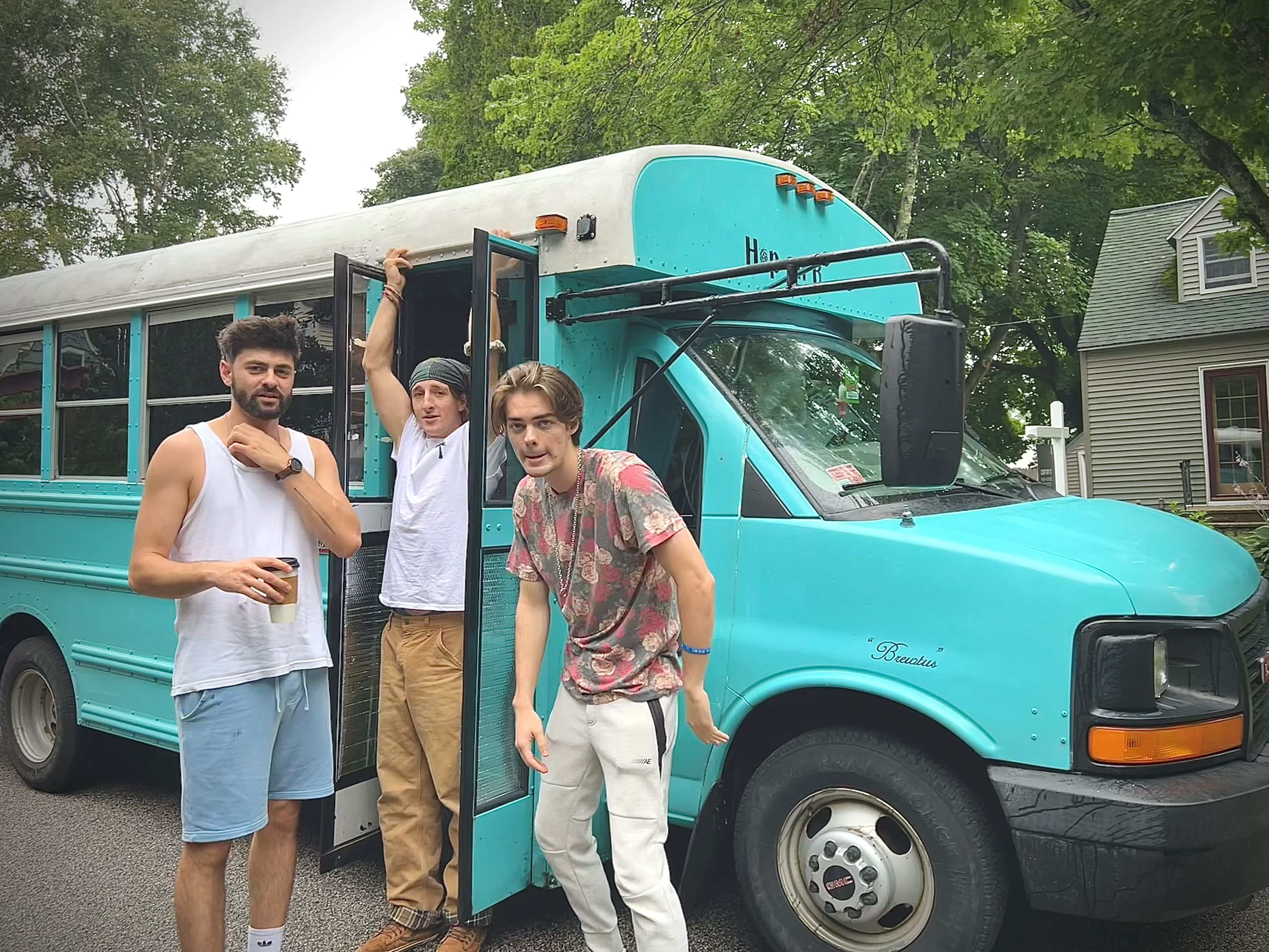 Nick Cassidy, Tyler Sebago, and Cash Cassidy pose for a photo next to Brewtus the bus.